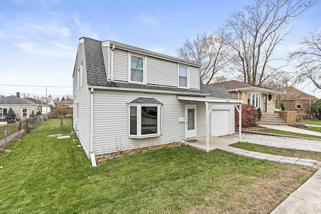 view of property with a front yard and a garage