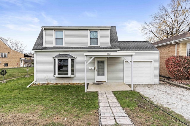 view of property featuring a garage and a front lawn