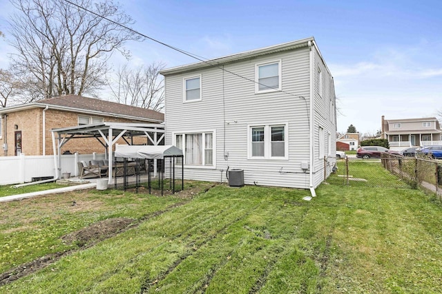 back of house featuring a gazebo, cooling unit, and a yard