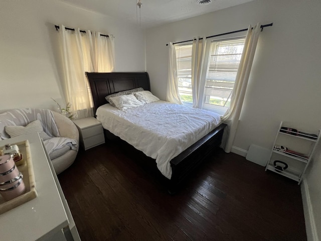 bedroom with dark wood-type flooring