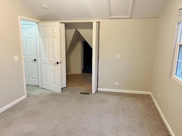 spare room featuring light carpet