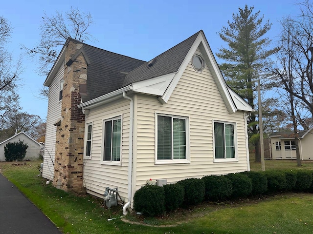 view of home's exterior with a lawn