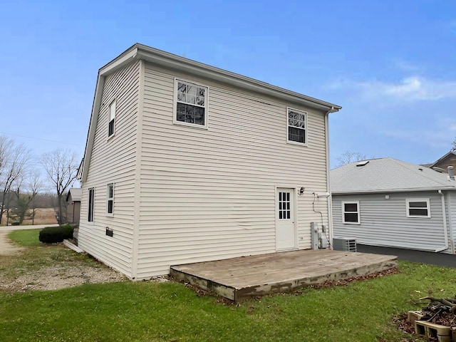 back of house with a wooden deck, a yard, a patio, and central AC