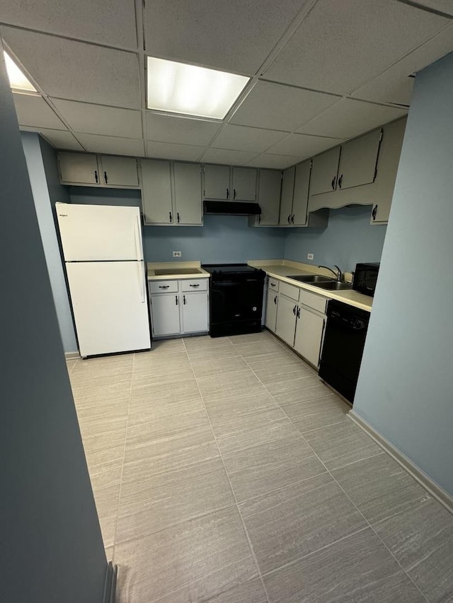 kitchen with black appliances, a paneled ceiling, gray cabinets, and sink