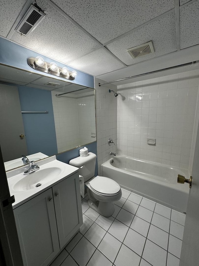 full bathroom featuring tile patterned flooring, tiled shower / bath combo, toilet, and vanity