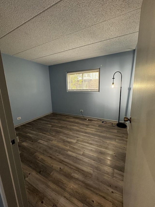 spare room with dark wood-type flooring