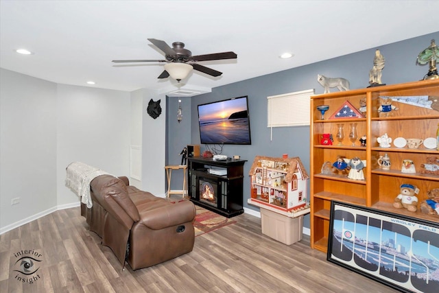 living room with ceiling fan and hardwood / wood-style floors