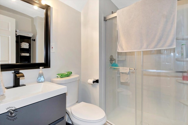 bathroom featuring walk in shower, vanity, and toilet