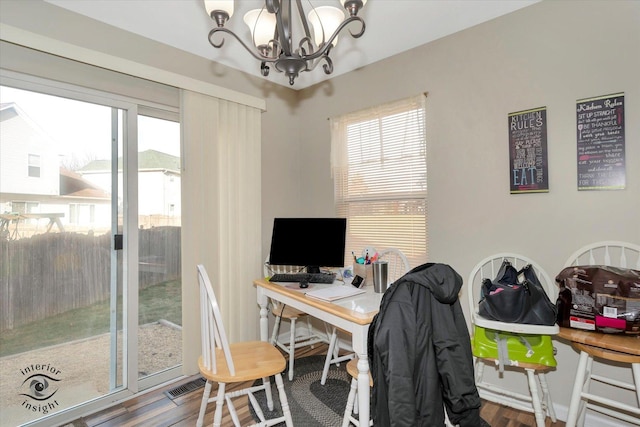 office featuring hardwood / wood-style floors, plenty of natural light, and an inviting chandelier