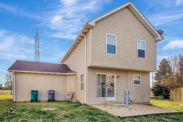 back of house with a yard and a patio area