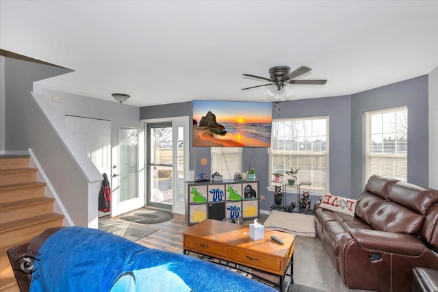 living room featuring ceiling fan and light hardwood / wood-style floors