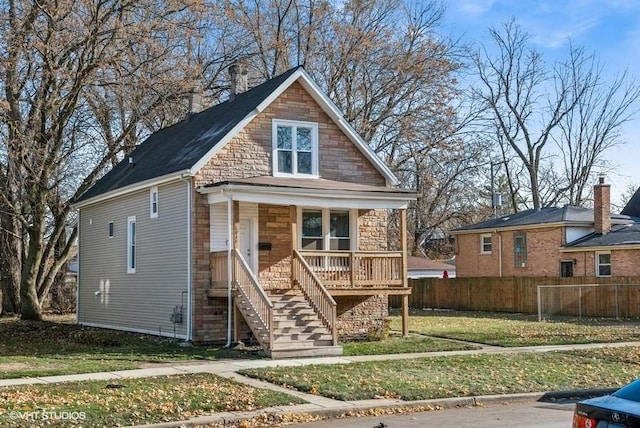 bungalow with a porch and a front yard