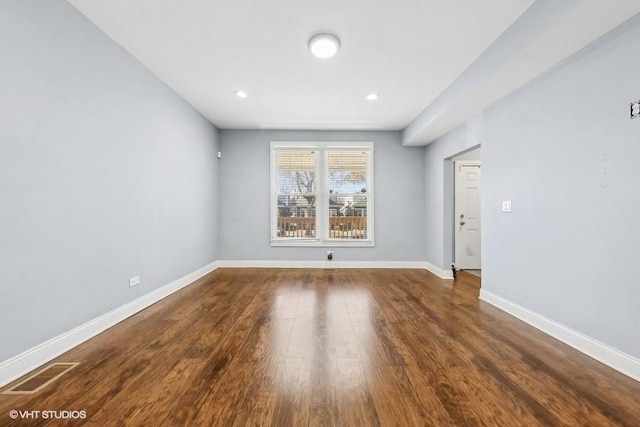 unfurnished room with dark hardwood / wood-style flooring