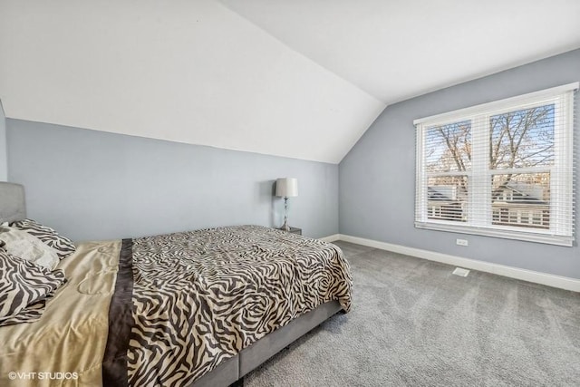 carpeted bedroom featuring lofted ceiling