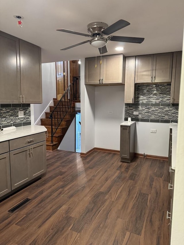 kitchen featuring backsplash, dark hardwood / wood-style floors, and ceiling fan