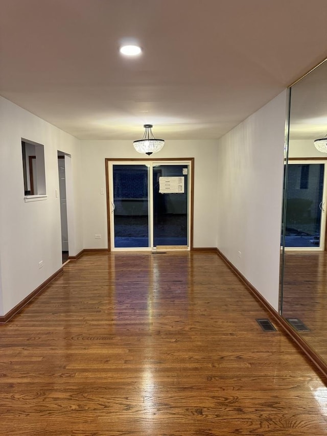 spare room featuring dark hardwood / wood-style flooring