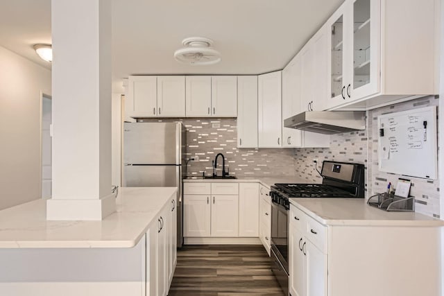 kitchen featuring appliances with stainless steel finishes, tasteful backsplash, light stone counters, sink, and white cabinets