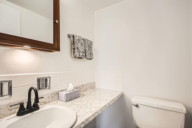 bathroom featuring decorative backsplash, vanity, and toilet