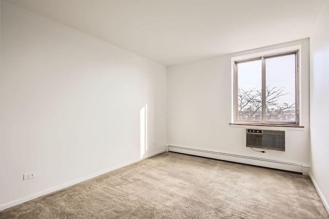 spare room with light carpet, a wall unit AC, and a baseboard heating unit