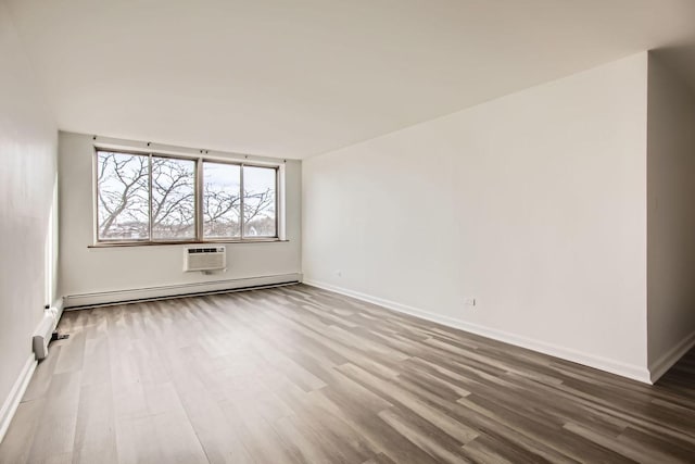 unfurnished room featuring a wall mounted AC, wood-type flooring, and a baseboard heating unit