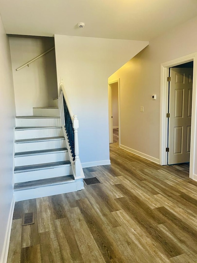 staircase featuring hardwood / wood-style flooring