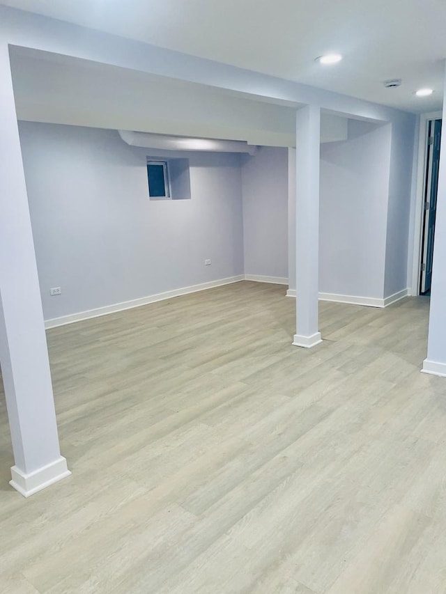 basement with light hardwood / wood-style flooring