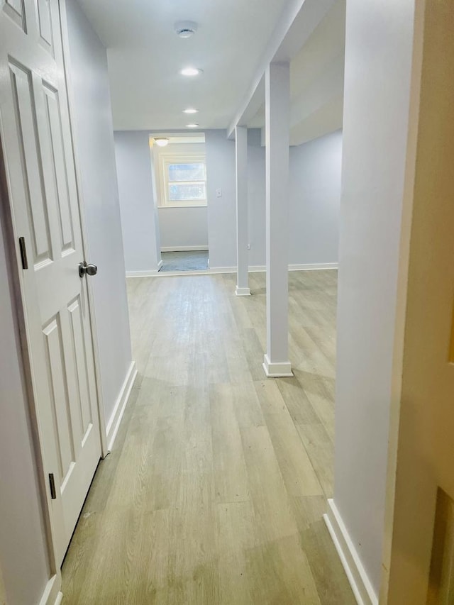 corridor with light hardwood / wood-style floors