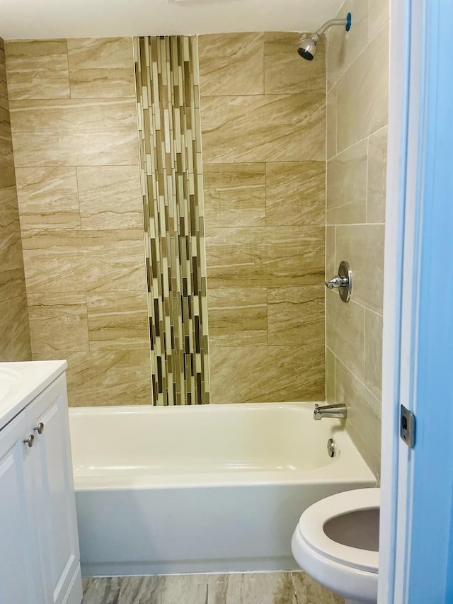 full bathroom with vanity, toilet, and tiled shower / bath