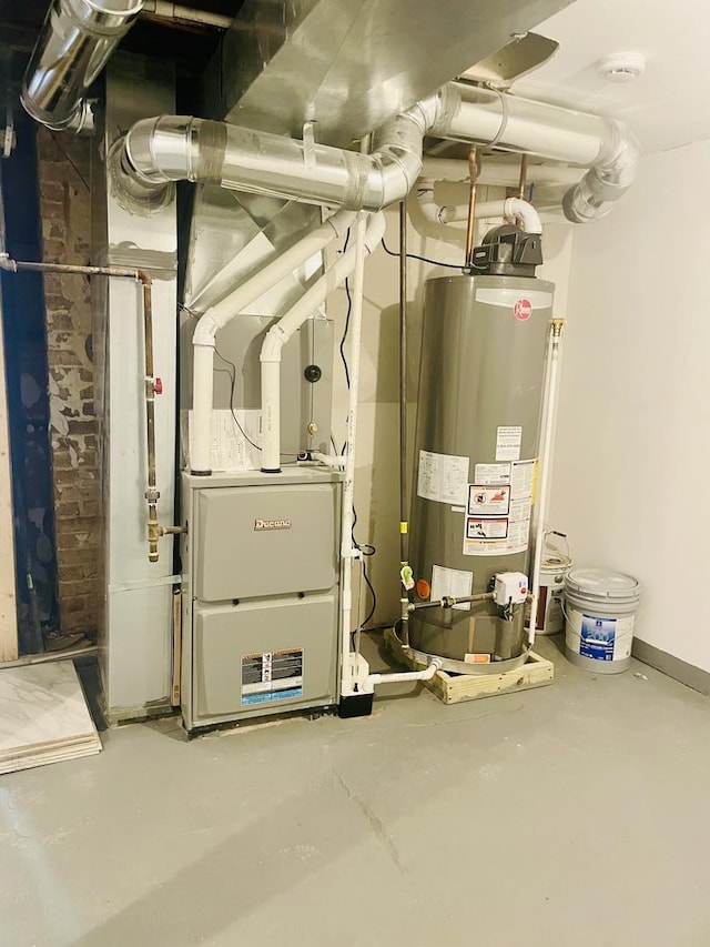 utility room featuring gas water heater