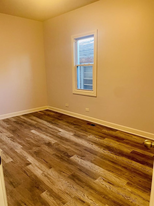 empty room with hardwood / wood-style flooring