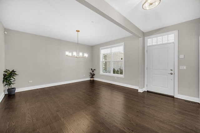 entryway with a notable chandelier and dark hardwood / wood-style flooring