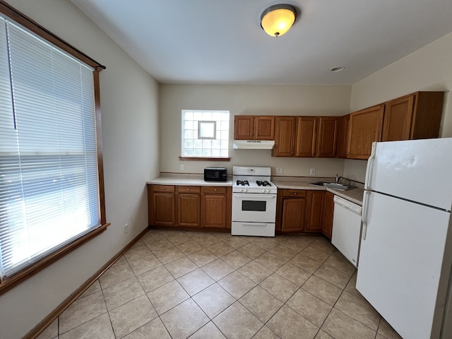 kitchen with sink, white appliances, and light tile patterned flooring