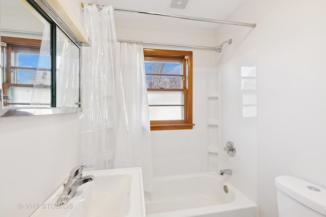 bathroom with shower / bath combination with curtain and toilet