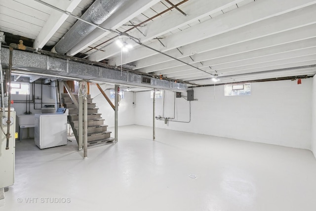 basement featuring washer / dryer and sink