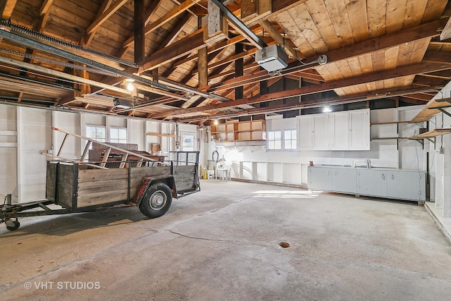 garage featuring wooden ceiling and a garage door opener