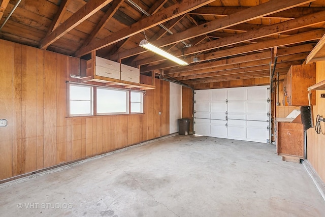 garage featuring wood walls