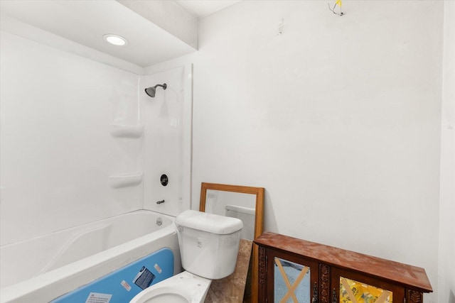 bathroom with bathtub / shower combination and toilet