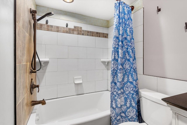 bathroom featuring shower / tub combo, toilet, and tile walls