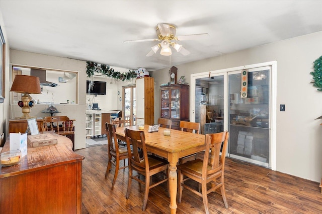 dining space with ceiling fan and dark hardwood / wood-style floors