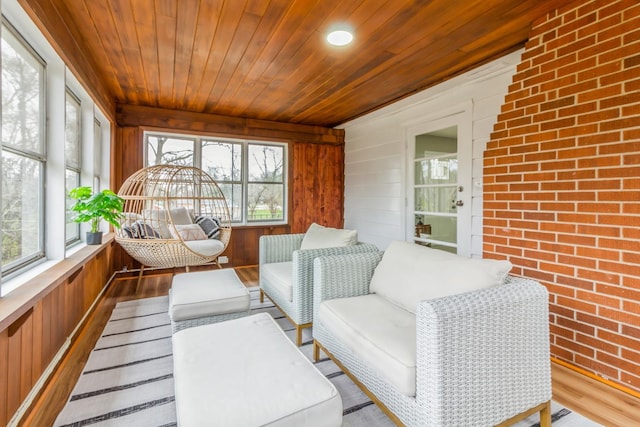 sunroom featuring wooden ceiling and a wealth of natural light