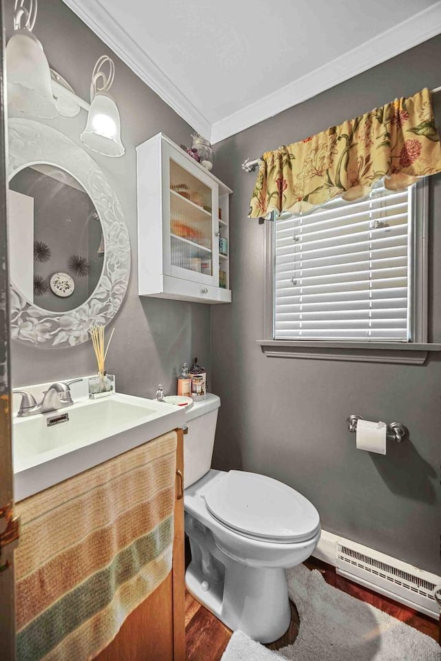 bathroom featuring vanity, crown molding, a baseboard radiator, hardwood / wood-style floors, and toilet