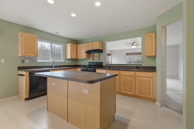 kitchen featuring a center island, black appliances, sink, ceiling fan, and light brown cabinetry