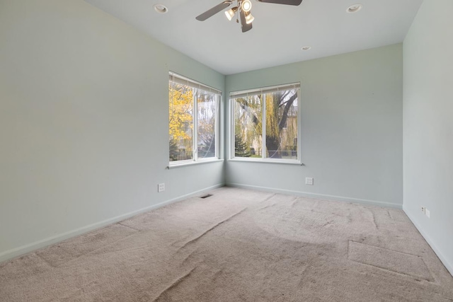 spare room featuring carpet and ceiling fan