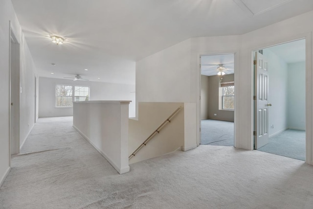 corridor with plenty of natural light and light carpet