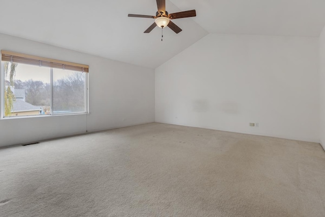 carpeted empty room featuring ceiling fan and lofted ceiling