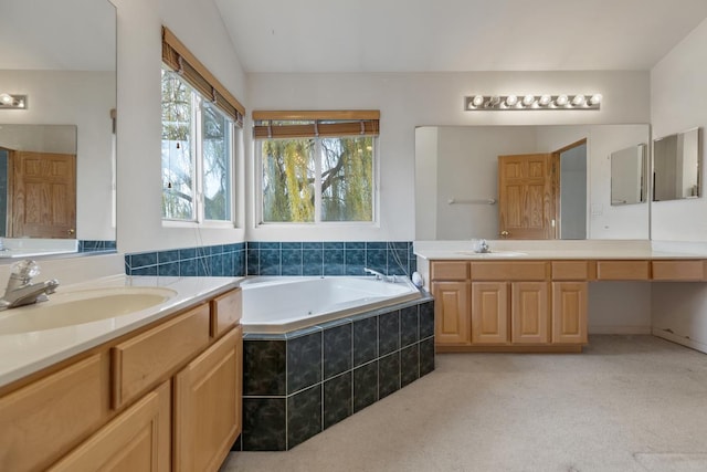 bathroom featuring vanity and a relaxing tiled tub