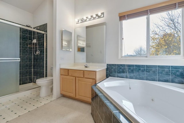 full bathroom featuring vanity, toilet, and separate shower and tub