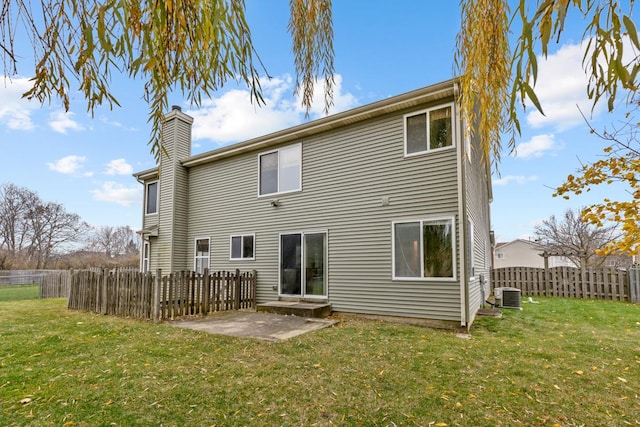 rear view of property with a lawn, central air condition unit, and a patio