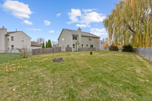 rear view of property featuring a lawn