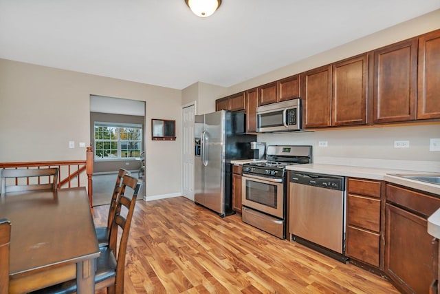 kitchen with light wood-type flooring and stainless steel appliances